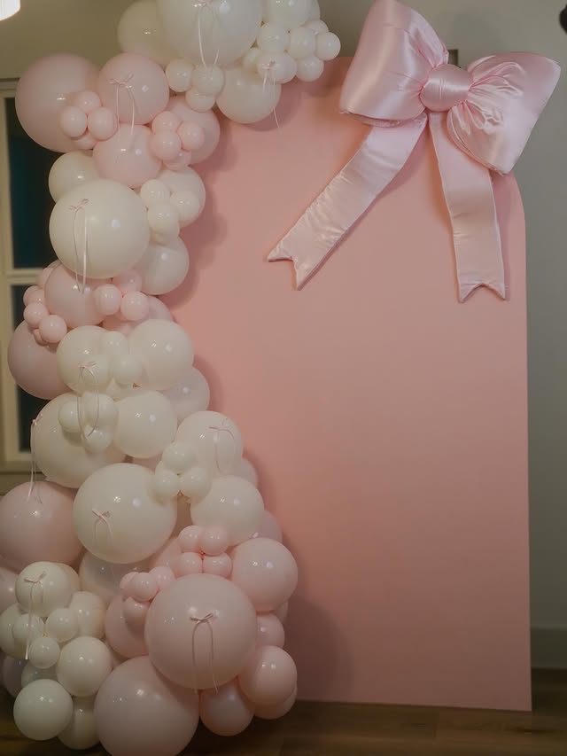 Blush pink balloon backdrop with bow by Lovely Pop Luxury Events